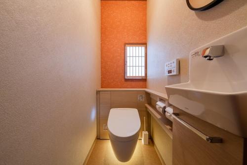 a small bathroom with a toilet and a sink at 金沢町家 凛 in Kanazawa