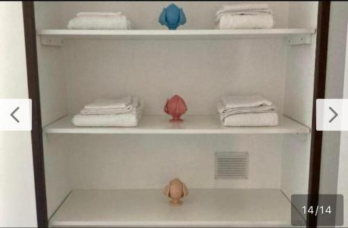 a white shelf with towels and towels on it at Casa Annacarla in Noci