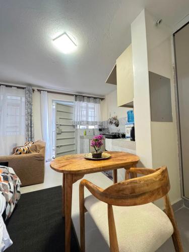 a kitchen and living room with a table and a couch at Sunrise Hills BNB in Ngong