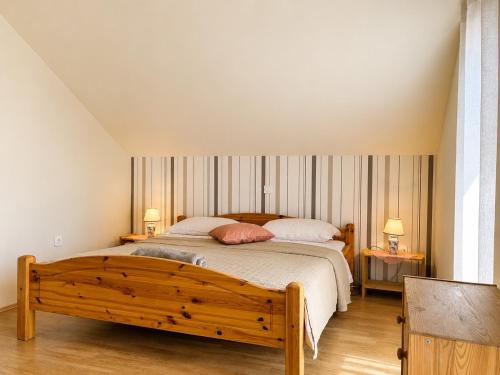 a bedroom with a large bed and two tables at Apartment House with Shared Pool in Premantura