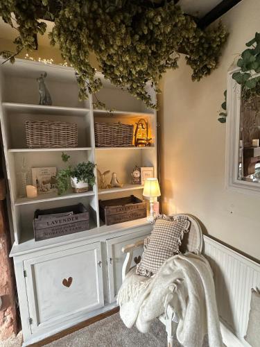 a room with a white hutch with baskets at Spring Cottage in Hoylake