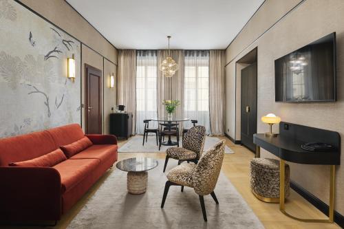 a living room with a couch and chairs and a table at Hotel Experior Boutique - Destigo Hotels in Krakow