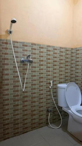 a bathroom with a shower with a toilet in it at Jayagiri Inn in Tangkubanperahu