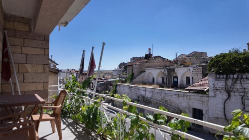 a balcony of a building with a table and chairs at Gumus Hotel in Ortahisar