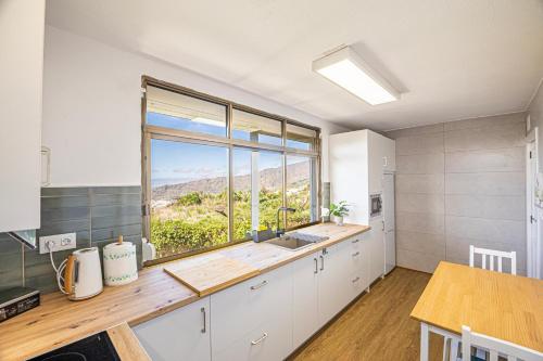 a kitchen with a sink and a large window at vv Mirador Al Mar in El Paso