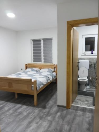 a bedroom with a bed and a toilet at Villa EMELA in Jajce