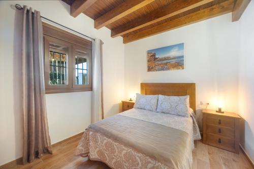 a bedroom with a bed and a window at Casa El Duque Zaira in Vejer de la Frontera