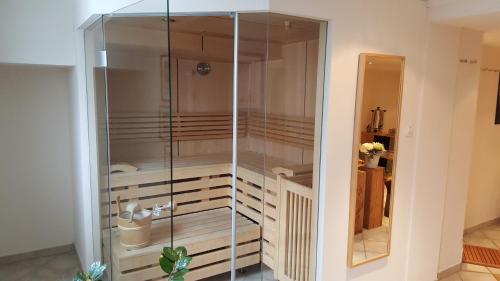 a glass cabinet in a living room with at Parseierblick in Sankt Anton am Arlberg