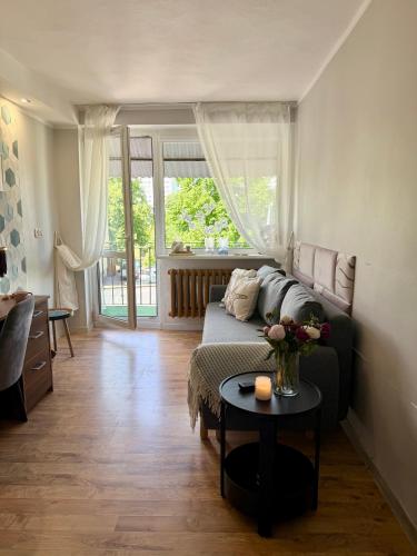 a living room with a couch and a table at Pokoje Gościnne in Kołobrzeg