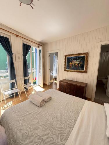 a bedroom with a large bed with two towels on it at Pension Alver - El Refugio del Artista in Cudillero