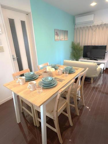 a dining room table with chairs and a couch at MARSEA Resort in Zushi