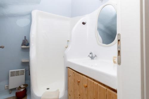 a bathroom with a sink and a mirror at Cycladic Boungainvillea Home in Kalafatis