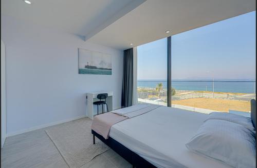 a bedroom with a bed and a view of the ocean at FOR LARGE FAMILIES, DUPLEX Vılla-304 in Çeşme