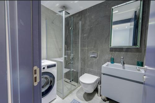 a bathroom with a toilet and a sink and a shower at FOR LARGE FAMILIES, DUPLEX Vılla-304 in Çeşme