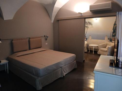 a bedroom with a bed and a living room at Hotel Italia in Noli
