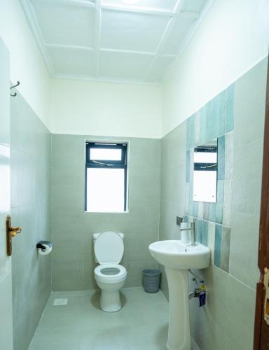 a bathroom with a toilet and a sink at Naisula Home in Naivasha