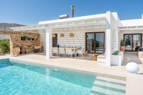 a villa with a swimming pool and a house at Revery Villa & House in Ios Chora