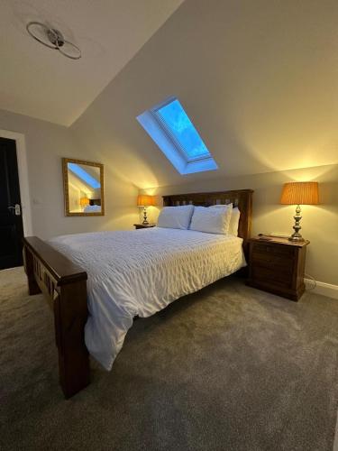 a bedroom with a large bed with a skylight at Homestay Wild Atlantic View Binghamstown in Belmullet