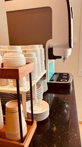 a kitchen counter with plates and a sewing machine at Hotel Alguer in L'Ametlla de Mar