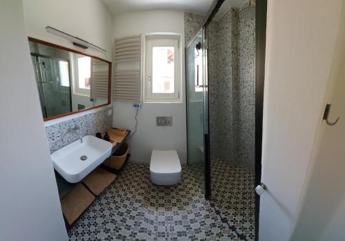 a bathroom with a toilet and a sink and a shower at Casa Morenica - Cementina in Montalto Dora