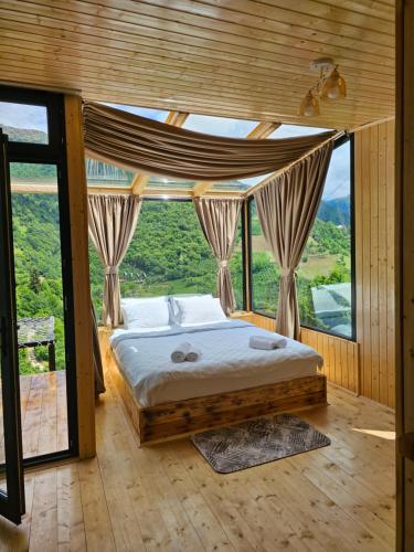 a bedroom with a bed in front of a large window at Merisi Horizon in K'eda
