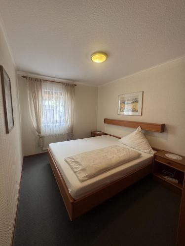 a bedroom with a large bed and a window at Ferienwohnung Hunsrückblick in Thalfang