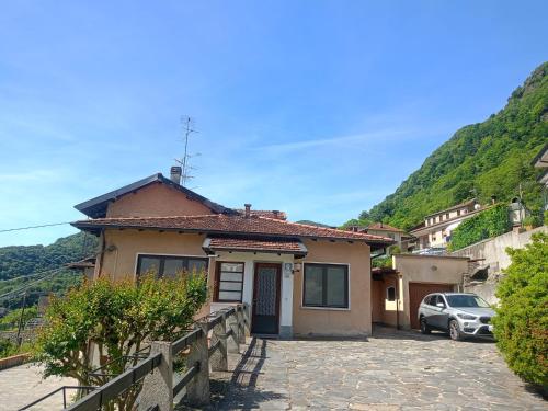 a house with a car parked in front of it at Casa Silvia Natura Relax, Sport & Family in Omegna
