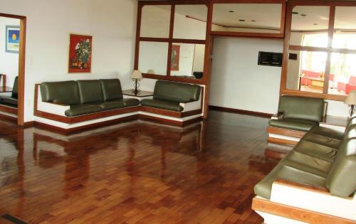 a lobby with couches and chairs in a room at Cazuza Palace Hotel in Tupã
