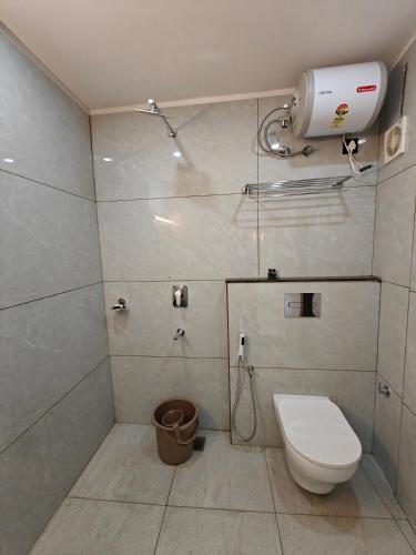 a small bathroom with a toilet and a shower at The Aspire Hotel Guwahati in Guwahati