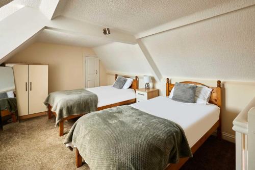a room with two beds in a attic at Host & Stay - Cobblers Cottage in Whitby