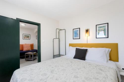 a bedroom with a large bed and a mirror at Casinha Peral Country Cottage in Peral