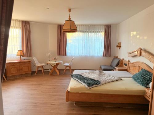 a bedroom with two beds and a living room at In & Out Boardinghaus in Stolberg