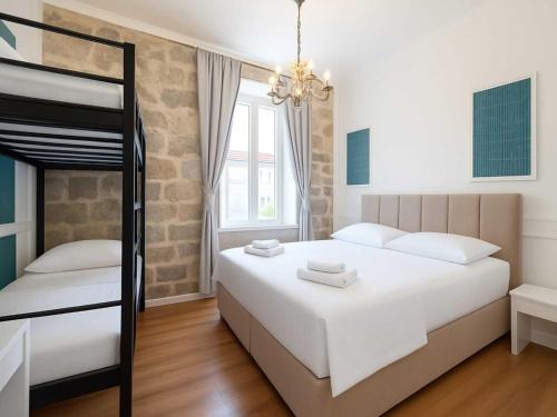 a bedroom with two beds and a bunk bed at Silver Gate Rooms-Diocletian's Palace in Split