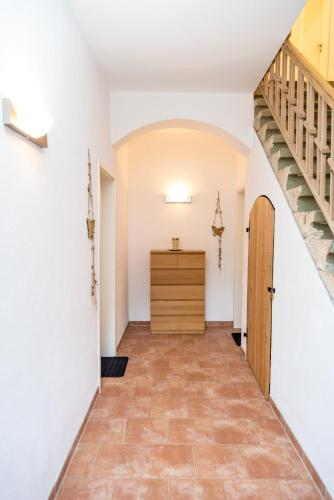 a hallway with white walls and a wooden door at Villa Elise in Bad Schandau