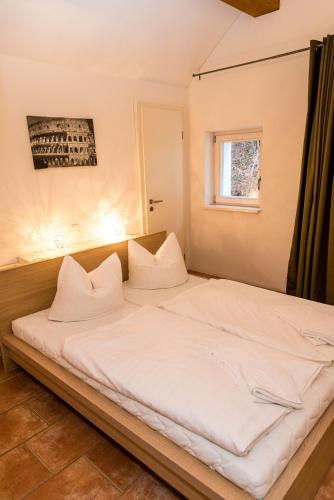 a large white bed in a room with a window at Villa Elise in Bad Schandau