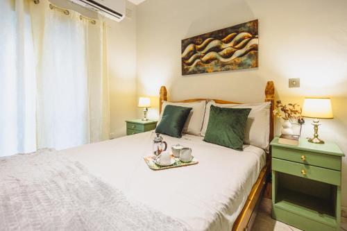 a bedroom with a bed with a tray on it at Savoy Signature Stays in Il-Gżira