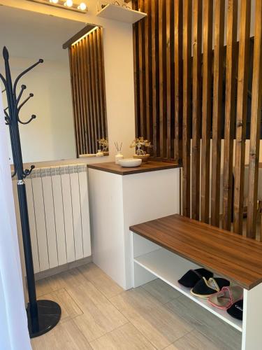 a room with a bench and a counter with shoes at Apartma Ložice in Deskle