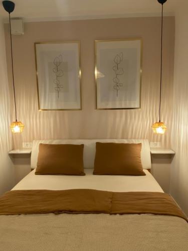 a bedroom with two pictures on the wall and a bed at Apartma Ložice in Deskle