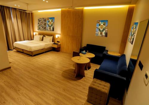 a hotel room with a bed and a couch at Hotel Fortune Plaza in Karnal