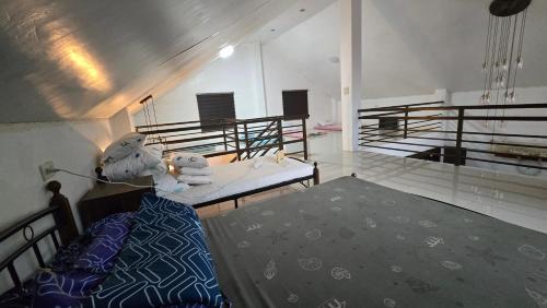 a bedroom with a bed and a balcony at DonnRaqui's Hidden Zen in Iligan