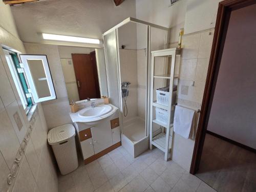 a small bathroom with a sink and a shower at Casa Centro Montargil in Montargil