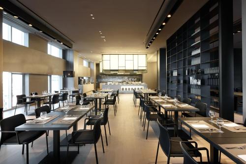 a restaurant with tables and chairs in a room at Shilla Stay Seocho Gangnam Station in Seoul