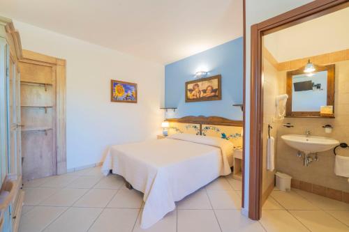 a hotel room with a bed and a sink at Sole del Mediterraneo in Otranto
