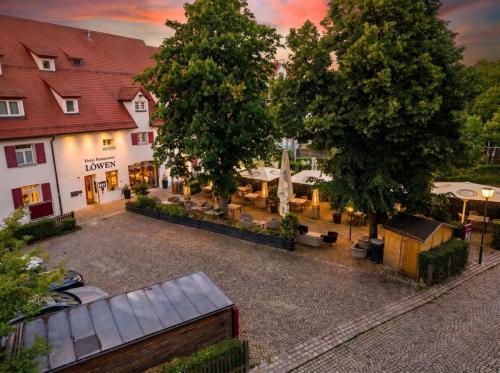 a view of a courtyard in a town with trees at Design Hotel & Restaurant Löwen in Ulm