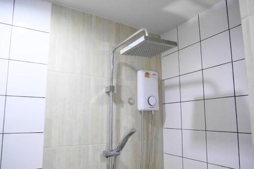 a shower with a shower head in a bathroom at Walking distance Thunder Dome in Ban Bang Phang