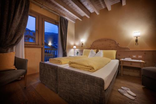 a bedroom with a large bed and a window at Bio Hotel Villa Cecilia in Livigno