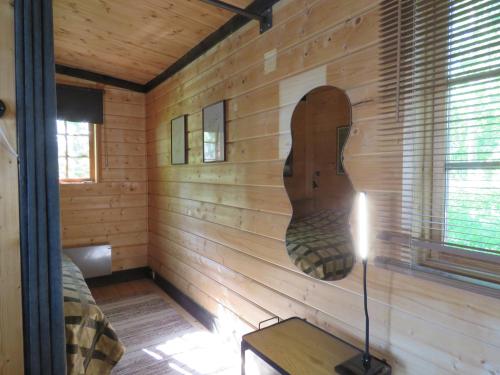 a room with a wooden wall with a large head on it at Villa Visioduuri in Savonlinna