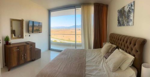 a bedroom with a bed and a large window at Mountains and sea in Boghaz