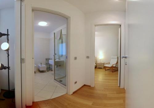 a hallway with a mirror and a door to a room at Golfo Gabella Lake Apartments in Maccagno Superiore