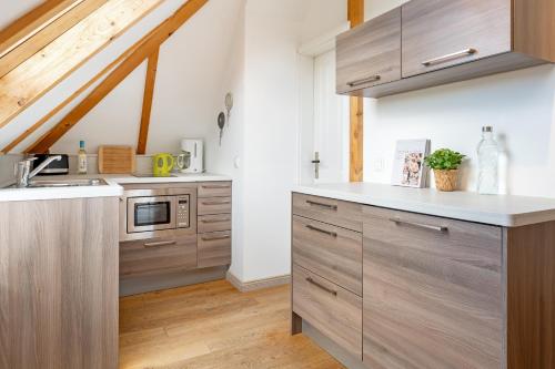 a kitchen with wooden cabinets and a counter top at Möwennest in Vitzdorf